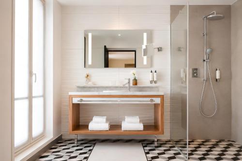 a bathroom with a sink and a shower at Hôtel Mayflower Opera in Paris