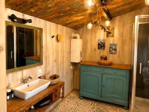 a bathroom with a sink and a mirror and a sink at Little Bali in Geel