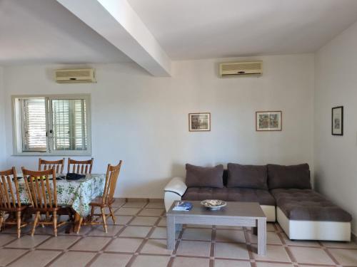a living room with a couch and a table at Beautiful Villa in Caccamo + Pool in Caccamo