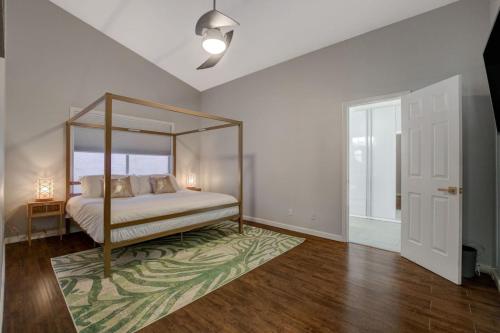 a bedroom with a canopy bed and a rug at Mirage Pool House - Heart of LV, Swimming Pool, Games, heavenly relaxation in Las Vegas