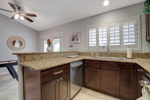 a kitchen with a sink and a ceiling fan at Mirage Pool House - Heart of LV, Swimming Pool, Games, heavenly relaxation in Las Vegas