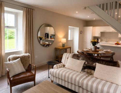 a living room with a couch and a table at Greenkeepers Cottage in Tobermory