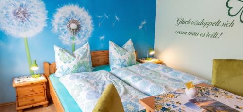 a bedroom with a bed with a dandelion wall at Charming House in Pruggern, Mountain View in Pruggern