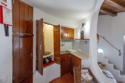 a small kitchen with wooden cabinets and a staircase at Albufeira Oasis Pool & Views in Albufeira