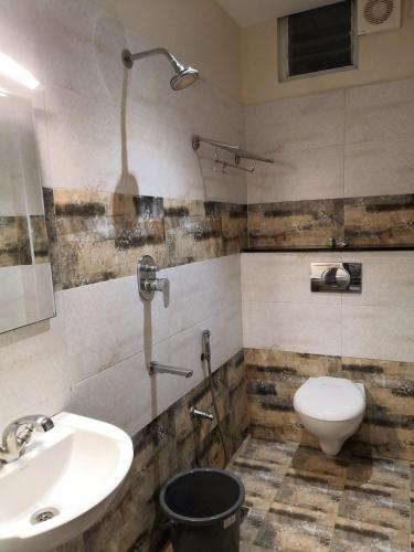 a bathroom with a sink and a toilet at TR Residency in Pondicherry