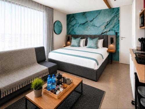 a hotel room with a bed and a couch at Burleigh Ballito in Ballito