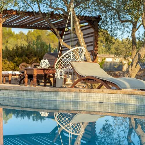 a patio with chairs and a table next to a pool at Spacious House with Private Pool in Stari Grad in Stari Grad