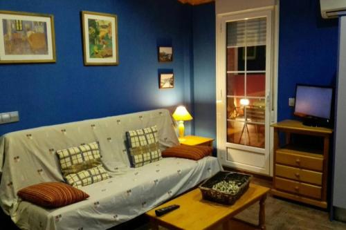 a living room with a white couch and a table at Charming Apartment in Castelserás - 60 sqm - Parking included in Castelserás
