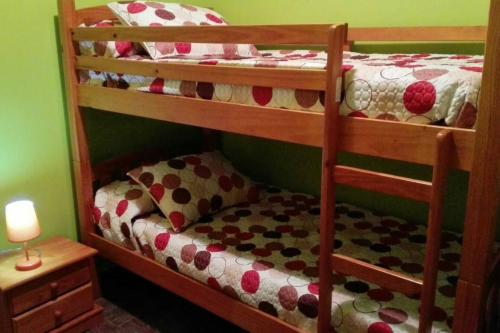 a bedroom with two bunk beds and a lamp at Charming Apartment in Castelserás - 60 sqm - Parking included in Castelserás