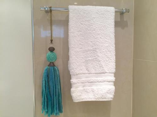 a bathroom with two towels and an umbrella at Luxury Apartment Tagle in Buenos Aires