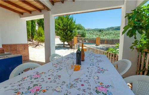 a long table with wine glasses on a balcony at Charming House in Montefrío with Private Pool in Montefrío