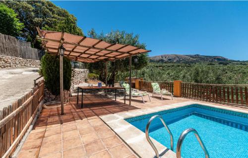 a patio with a table and an umbrella next to a pool at Charming House in Montefrío with Private Pool in Montefrío
