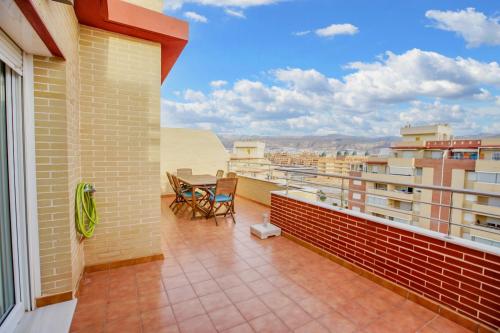 a balcony with a table and chairs on a building at Modern apartment in Roquetas de Mar with sea view in Roquetas de Mar