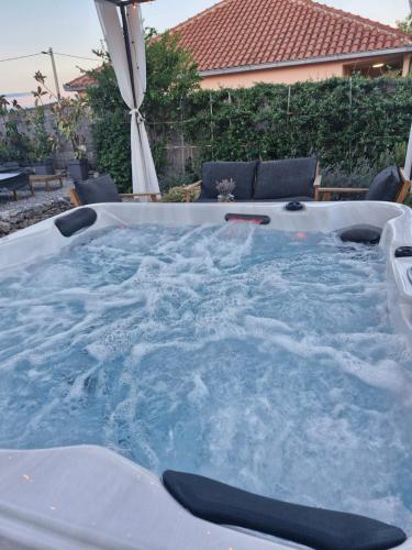 a jacuzzi hot tub in a backyard at Rural home Basin dvor with jacuzzi in Vinišće