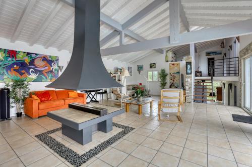a living room with a couch and a fireplace at Villa spacieuse à Bidart avec piscine privée 330 m² in Bidart