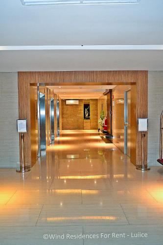 a lobby of a hotel with a hallway of a building at Wind Residences For Rent - Luiice in Tagaytay