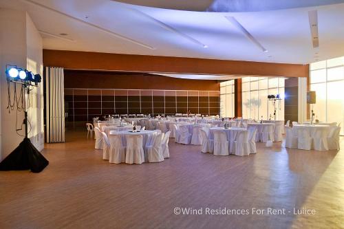 a banquet hall with white tables and white chairs at Wind Residences For Rent - Luiice in Tagaytay