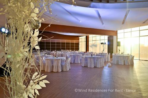 a large banquet hall with white tables and chairs at Wind Residences For Rent - Luiice in Tagaytay