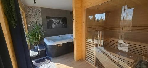 a bathroom with a tub and a sink and a shower at Domek SPA z sauną i jacuzzi - Level780 in Koszarawa