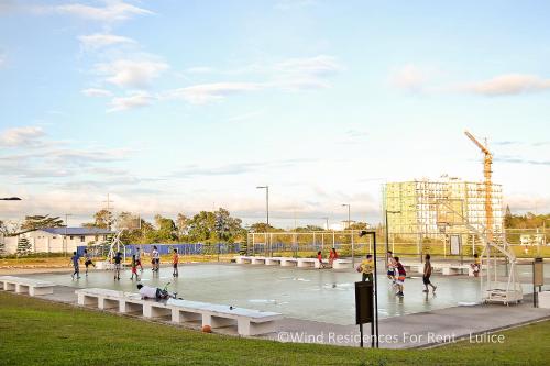 a group of people playing on a basketball court at Wind Residences For Rent - Luiice in Tagaytay