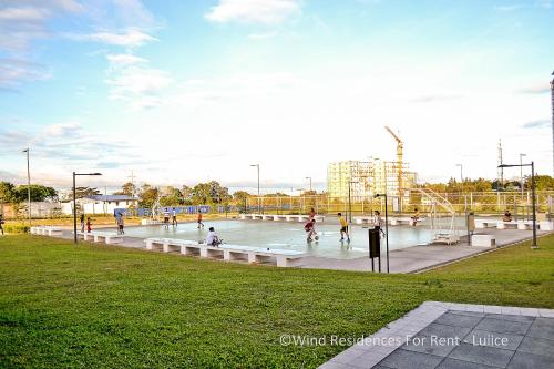 a group of people playing in a park at Wind Residences For Rent - Luiice in Tagaytay