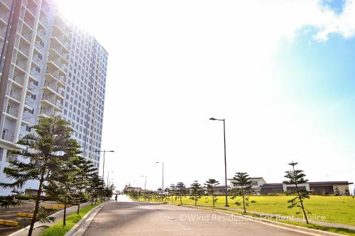 an empty street in front of a tall building at Wind Residences For Rent - Luiice in Tagaytay