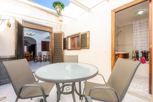 a dining room with a glass table and chairs at House by the sea in Can Picafort with terrace in Can Picafort
