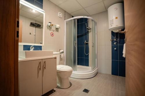 a bathroom with a shower and a toilet and a sink at Park Lakeside Ohrid in Ohrid