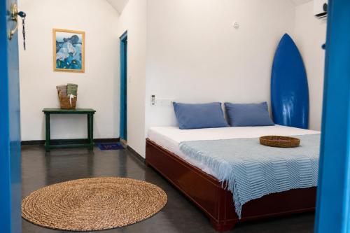 a bedroom with a bed with a surfboard on it at Zen Yoga & Surf House in Arugam Bay