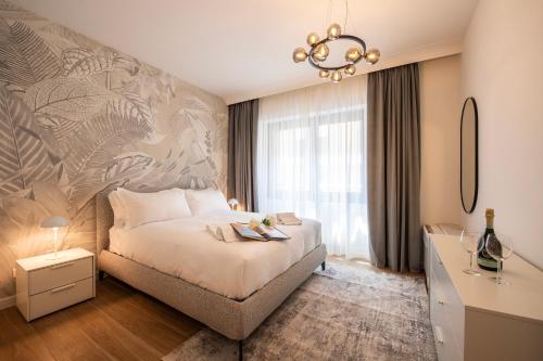 a bedroom with a large bed and a chandelier at Boutique Suites in Lugano