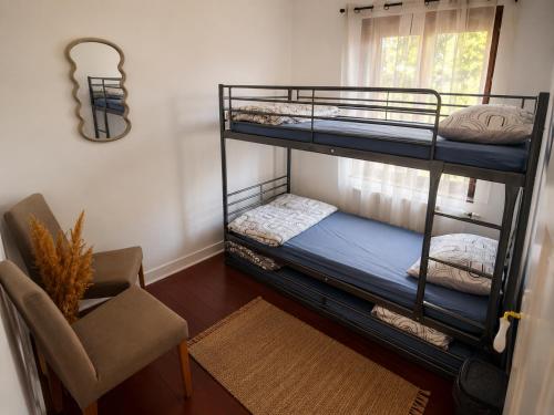 a room with two bunk beds and a chair at Maison Traversière in Long de Bout