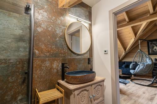 a bathroom with a sink and a mirror at Przytulisko Bieszczady in Smerek