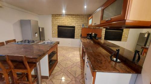 a kitchen with a sink and a counter top at Maison élégante à Saint-Pierre + Piscine in Casabona