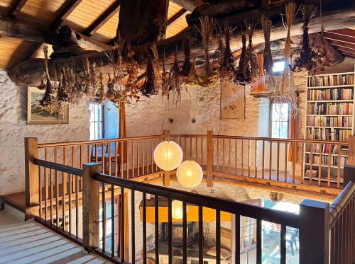 a staircase in a building with chandeliers and books at Maison charmante à Valleraugue avec piscine partagée. in Valleraugue