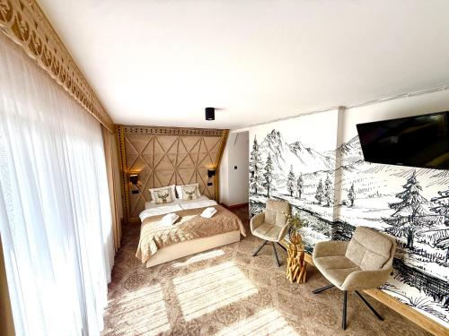 a bedroom with a bed and a tv in a room at Willa Regina II Resort & SPA in Zakopane