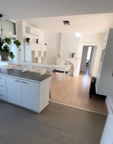 a kitchen and living room with a table and chairs at la casa de gege in Mellet