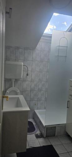 a bathroom with a toilet and a sink at Fine Rest- City Center Apartment in Brčko