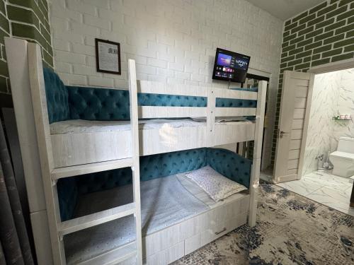 two bunk beds in a room with a bathroom at Samdarvoza in Tashkent
