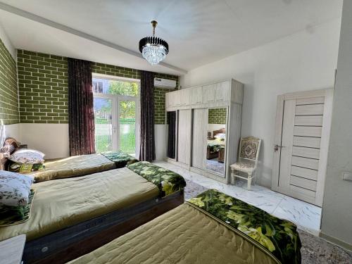 a bedroom with two beds and a window at Samdarvoza in Tashkent