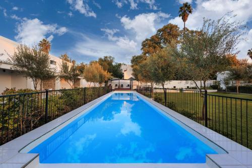 a swimming pool in the backyard of a house at Karoo Retreat- Self Catering Villas and Guest House in Oudtshoorn