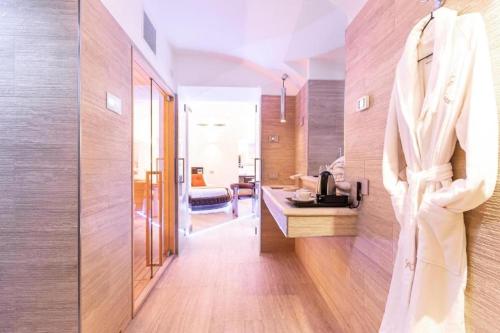 a hallway of a hotel room with a robe hanging on a wall at Relais V&G in Anagni