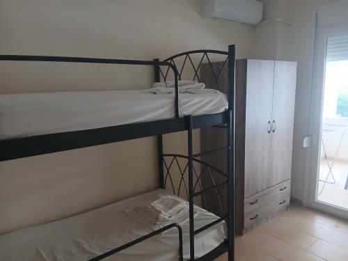 a room with two bunk beds and a cabinet at Aphroditi Luxury Vila in Chrysi Ammoudia
