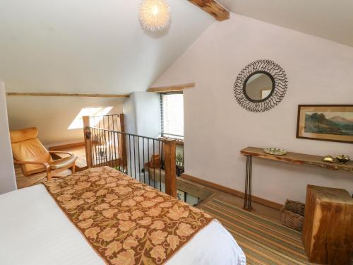 a bedroom with a bed and a table and a mirror at The Brew House in Penrith