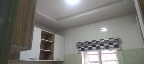 a kitchen with a window and a sink and a window at PAUL's PLACE in Loburo