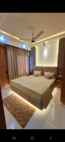 a bedroom with a large bed with a ceiling at Cube Stay in Bhopal