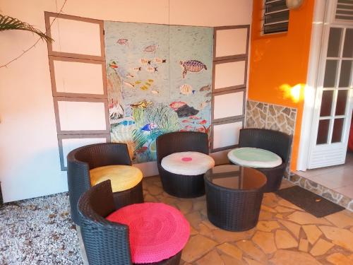 a group of chairs and tables in a room at Appartement charmant à Sainte-Luce avec vue sur la montagne in Sainte-Luce