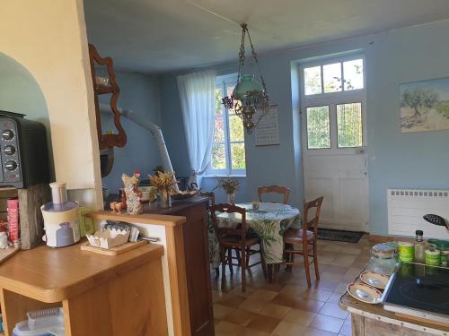 a kitchen with a table and a dining room at Charming room in Sornay