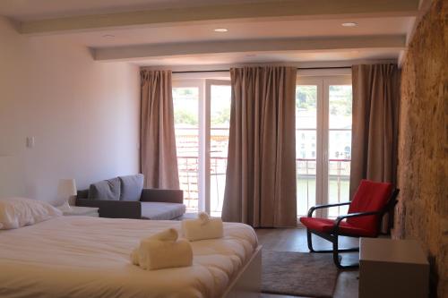 a bedroom with a bed and a couch and a chair at Gaia River View in Vila Nova de Gaia