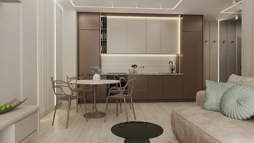a kitchen and living room with a table and a couch at Apartamenty Kościuszki Winda Klimatyzacja in Iława