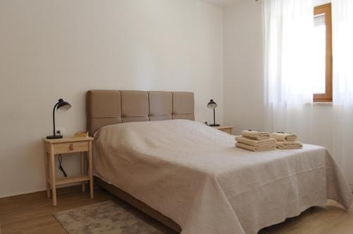 a bedroom with a bed with two towels on it at Villa GB in Brtonigla